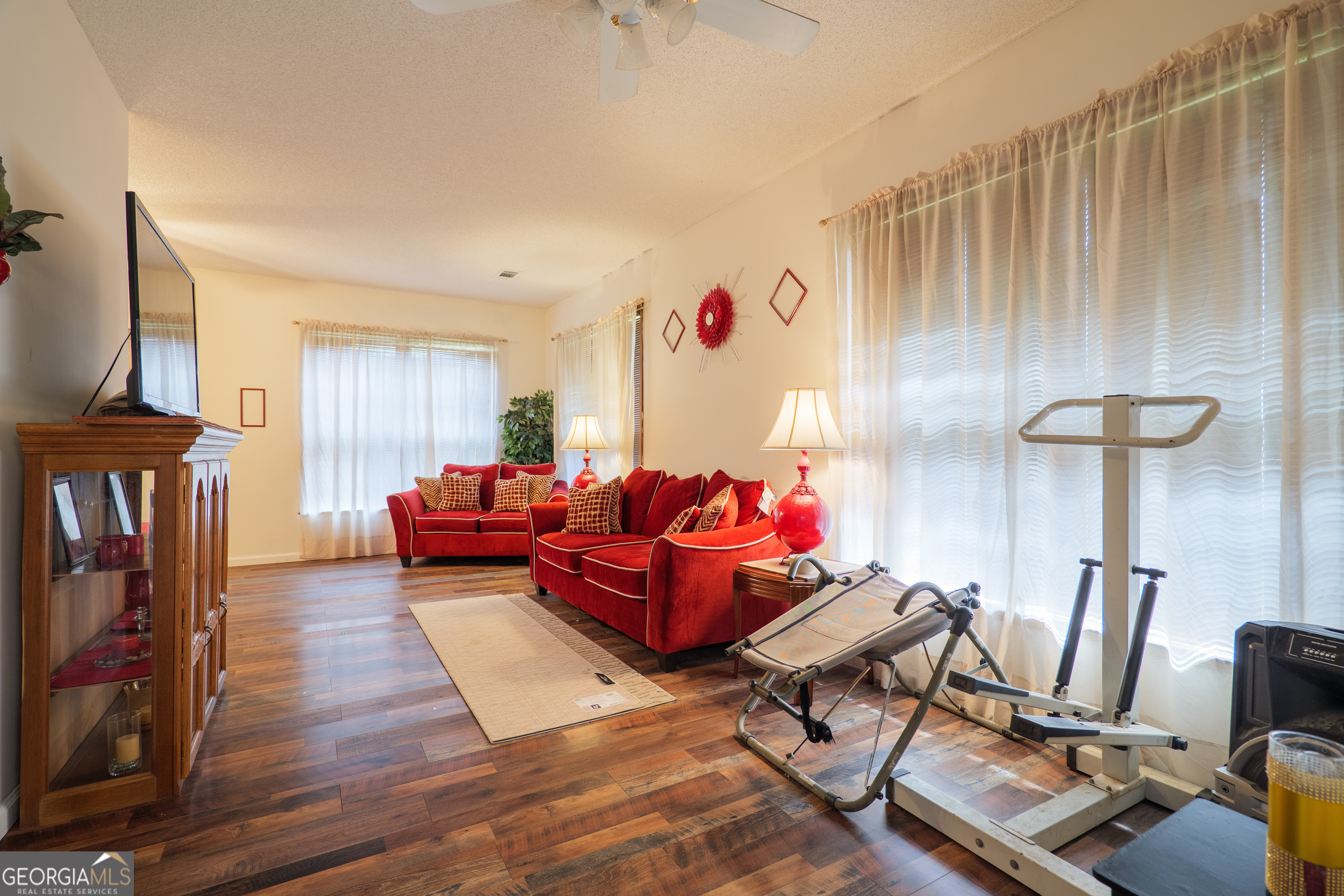 3473 Kay Circle Valdosta, GA 31606 - Photo 47 of 79 a living room with furniture a fireplace and a flat screen tv