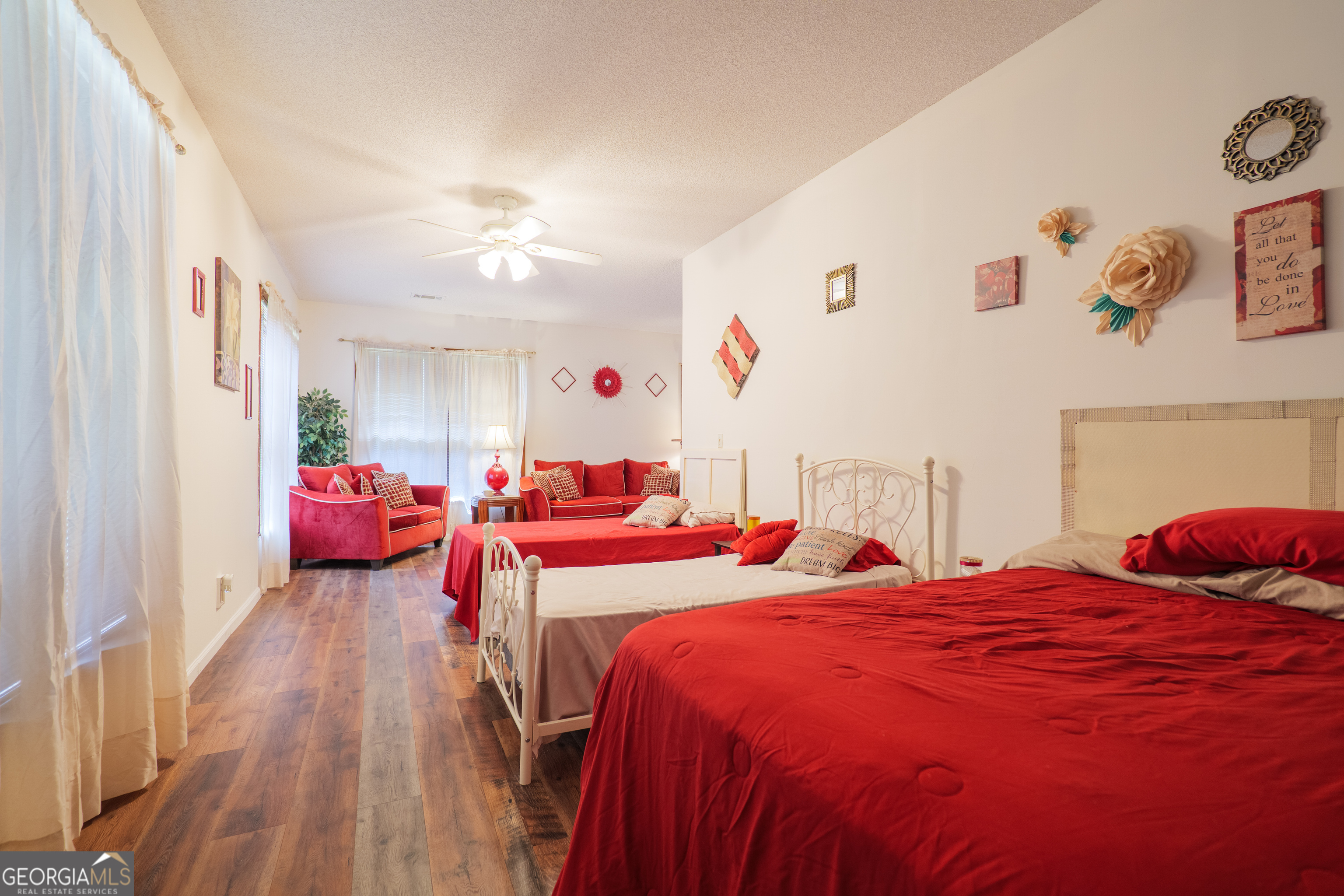 3473 Kay Circle Valdosta, GA 31606 - Photo 49 of 79 a bedroom with two beds and a chandelier