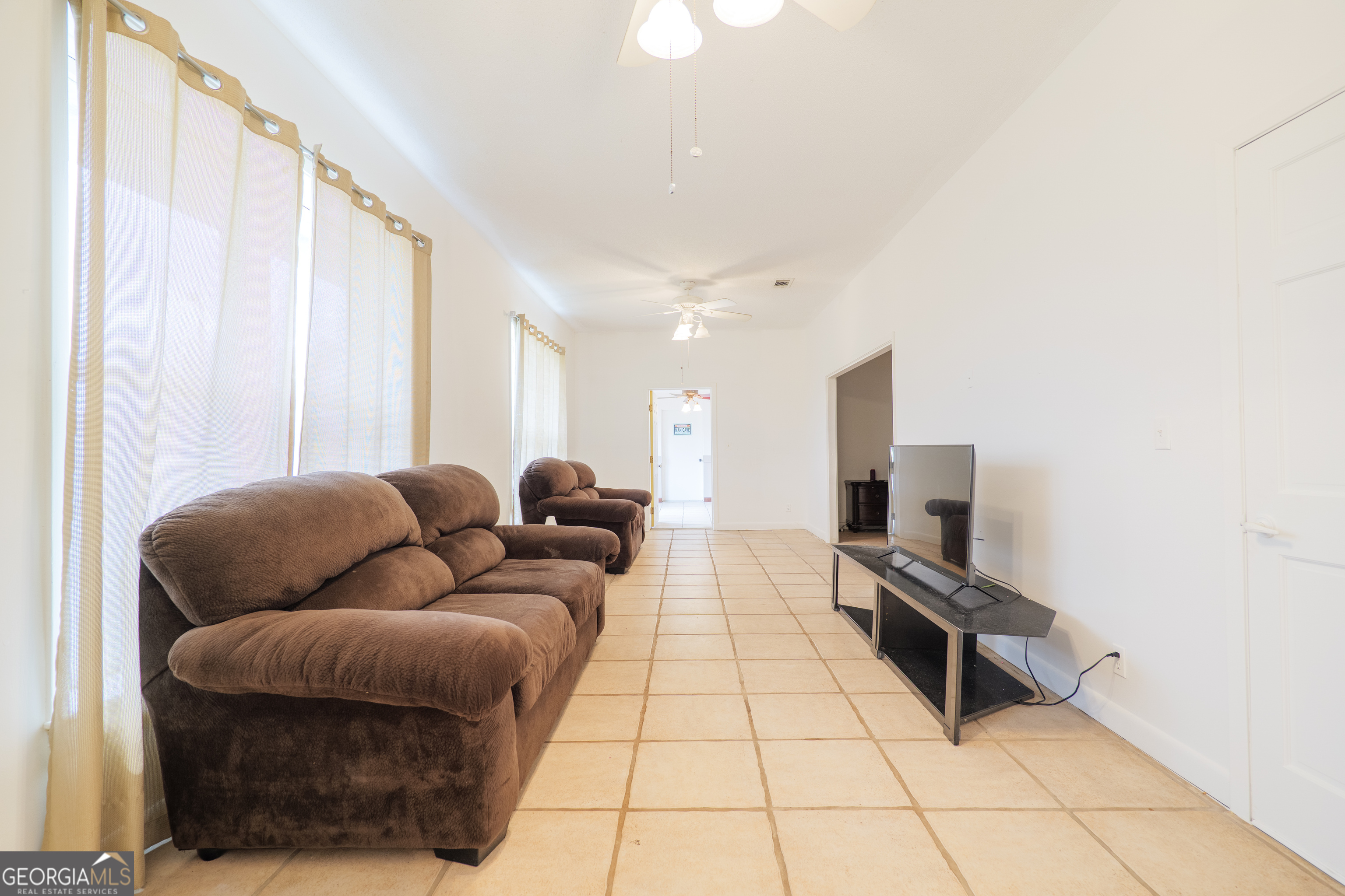 3473 Kay Circle Valdosta, GA 31606 - Photo 50 of 79 a living room with furniture a flat screen tv and a window