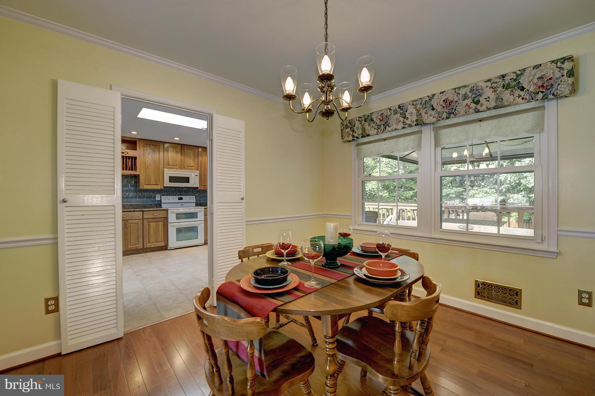 8609 Woodview Drive Springfield, VA 22153 - Photo 15 of 28 a view of a dining room with furniture window and wooden floor