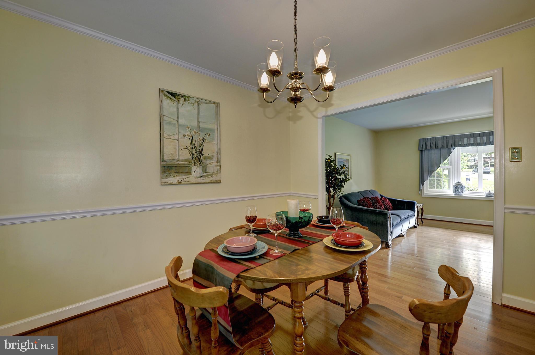 8609 Woodview Drive Springfield, VA 22153 - Photo 16 of 28 a view of a dining room with furniture and chandelier