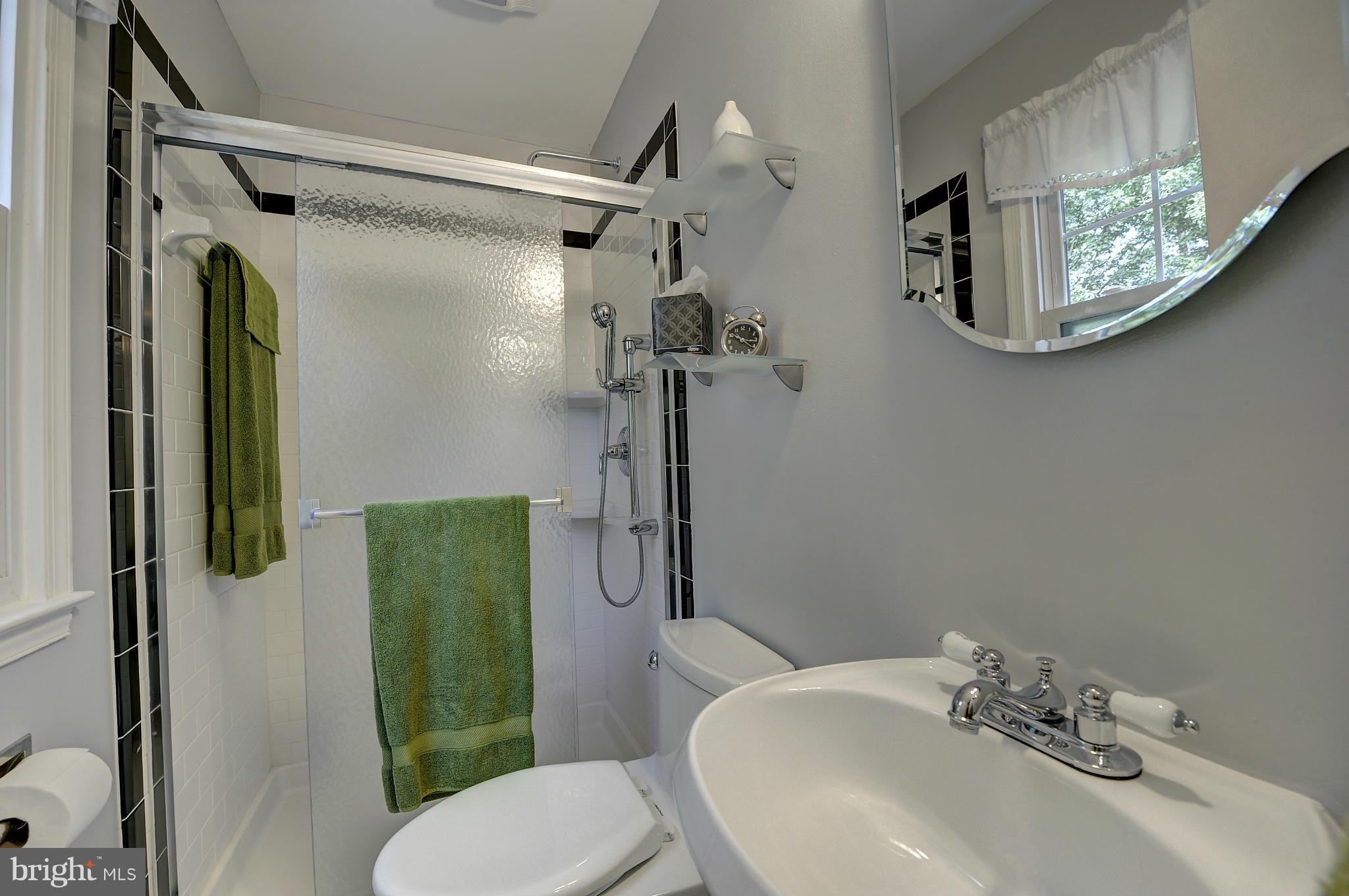 8609 Woodview Drive Springfield, VA 22153 - Photo 18 of 28 a bathroom with a sink toilet and shower