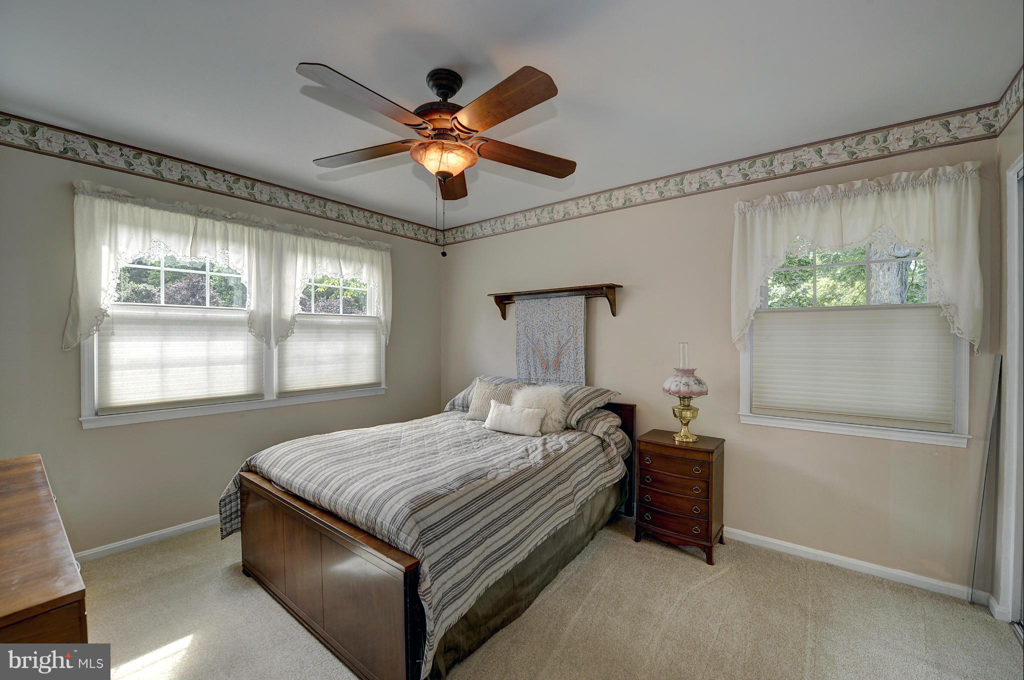 8609 Woodview Drive Springfield, VA 22153 - Photo 19 of 28 a bedroom with a bed and a large window