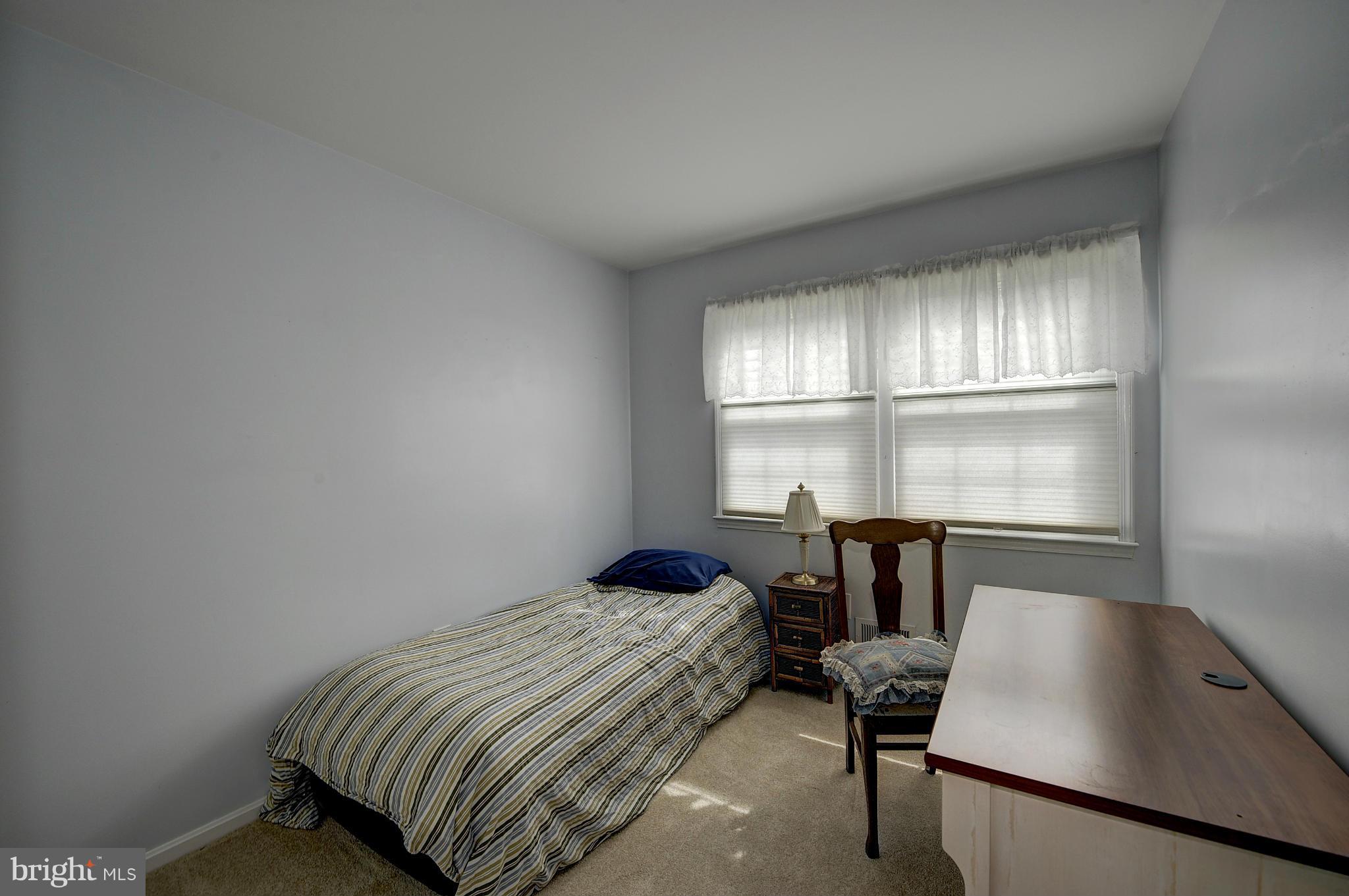 8609 Woodview Drive Springfield, VA 22153 - Photo 21 of 28 a bedroom with a bed and a window
