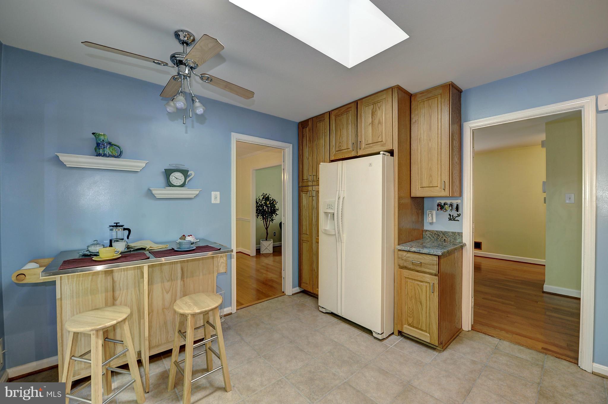 8609 Woodview Drive Springfield, VA 22153 - Photo 23 of 28 a view of a kitchen with refrigerator and cabinets