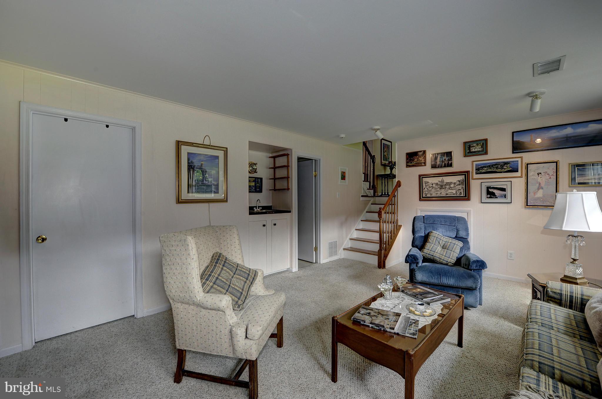 8609 Woodview Drive Springfield, VA 22153 - Photo 24 of 28 a living room with furniture and a couch