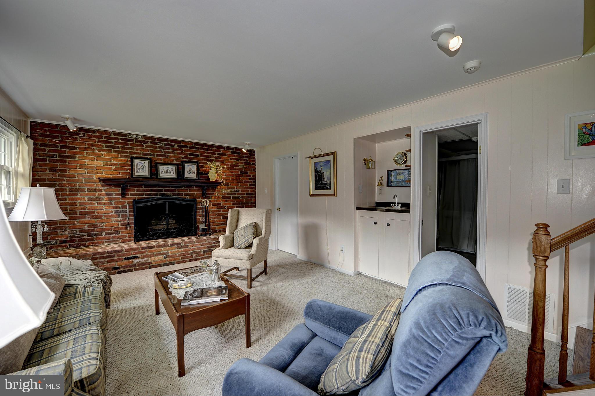 8609 Woodview Drive Springfield, VA 22153 - Photo 25 of 28 a living room with furniture and a fireplace