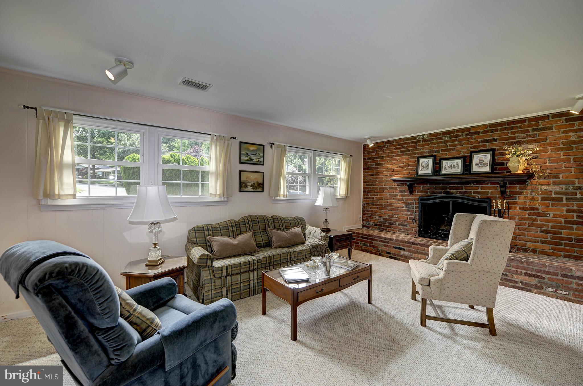 8609 Woodview Drive Springfield, VA 22153 - Photo 26 of 28 a living room with furniture and a fireplace