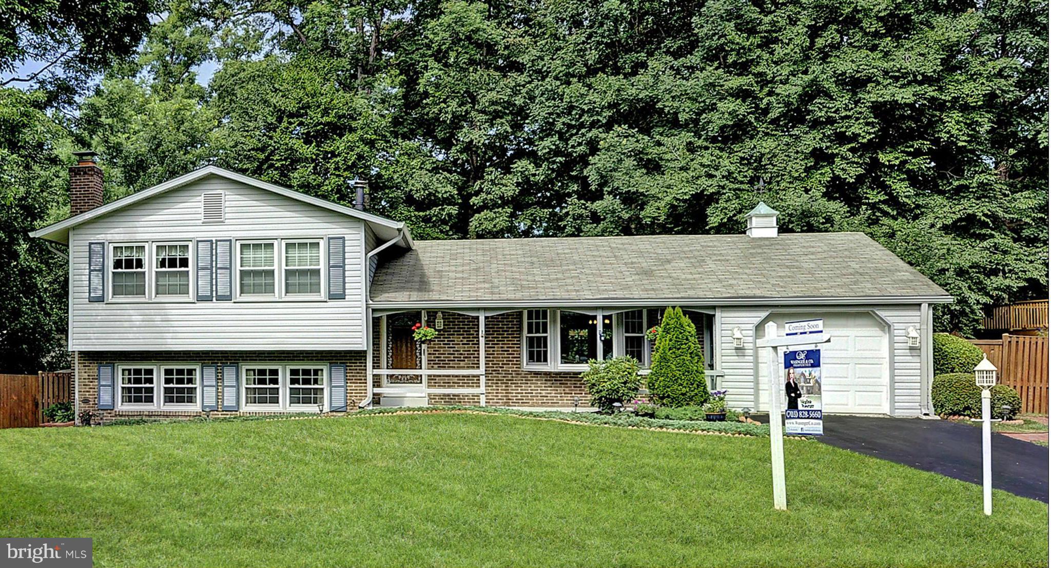 8609 Woodview Drive Springfield, VA 22153 - Photo 28 of 28 a front view of a house with a garden