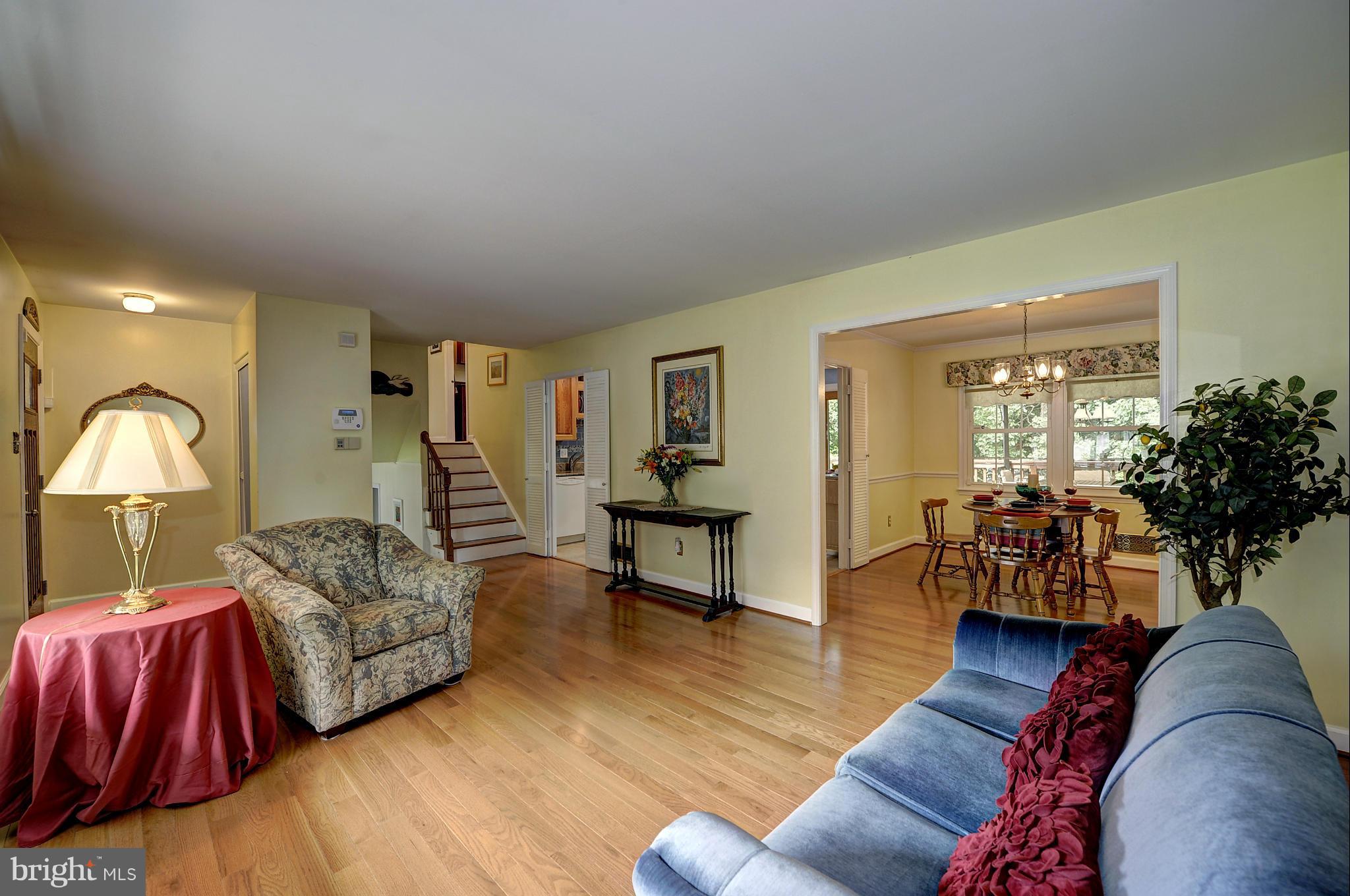 8609 Woodview Drive Springfield, VA 22153 - Photo 10 of 28 a living room with furniture a lamp wooden floor and a large window