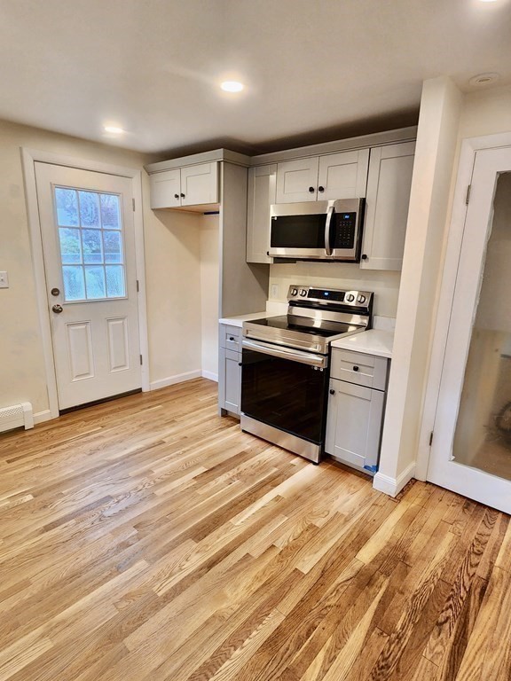 76 Bradley Rd Extension Braintree, MA 02184 - Photo 17 of 19 a kitchen with stainless steel appliances granite countertop a stove and a refrigerator