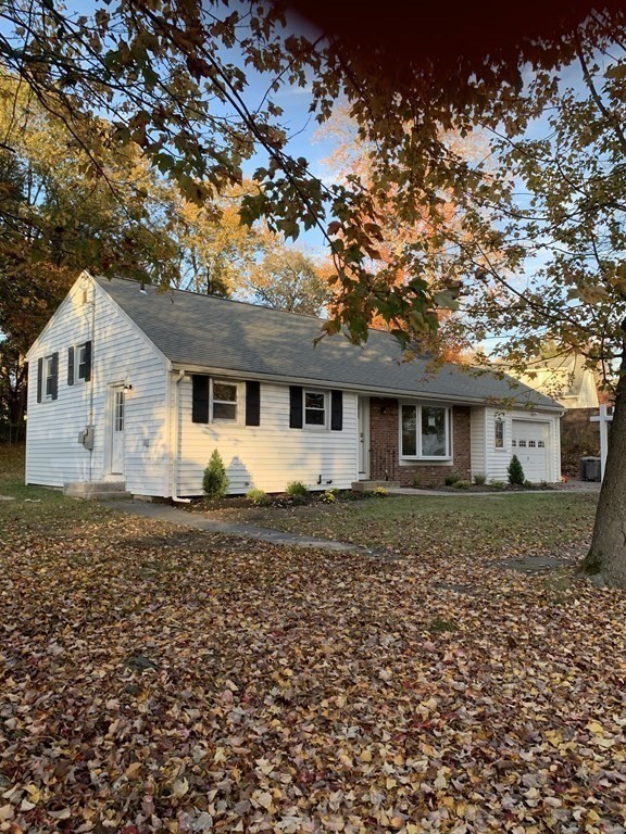 76 Bradley Rd Extension Braintree, MA 02184 - Photo 2 of 19 a front view of a house with a garden