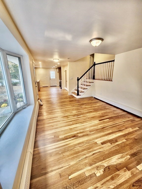 76 Bradley Rd Extension Braintree, MA 02184 - Photo 5 of 19 a view of a room with wooden floor and windows