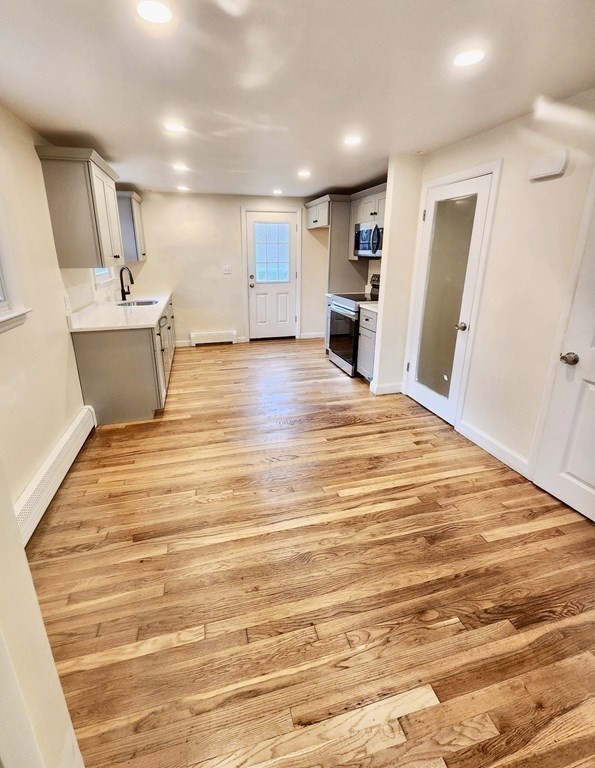 76 Bradley Rd Extension Braintree, MA 02184 - Photo 6 of 19 a view of a kitchen with cabinets and wooden floor