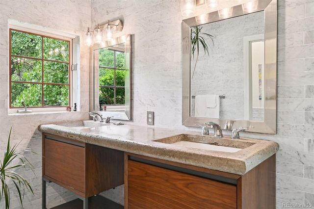 a view of spacious bathroom with furniture and windows