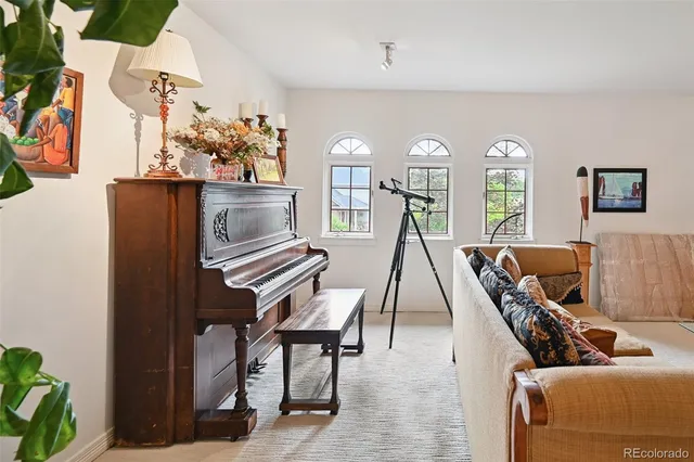 a living room with furniture and a chandelier