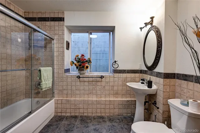 a living room with furniture and floor to ceiling window