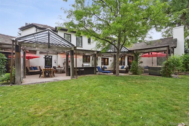 a view of a house with a yard and sitting area
