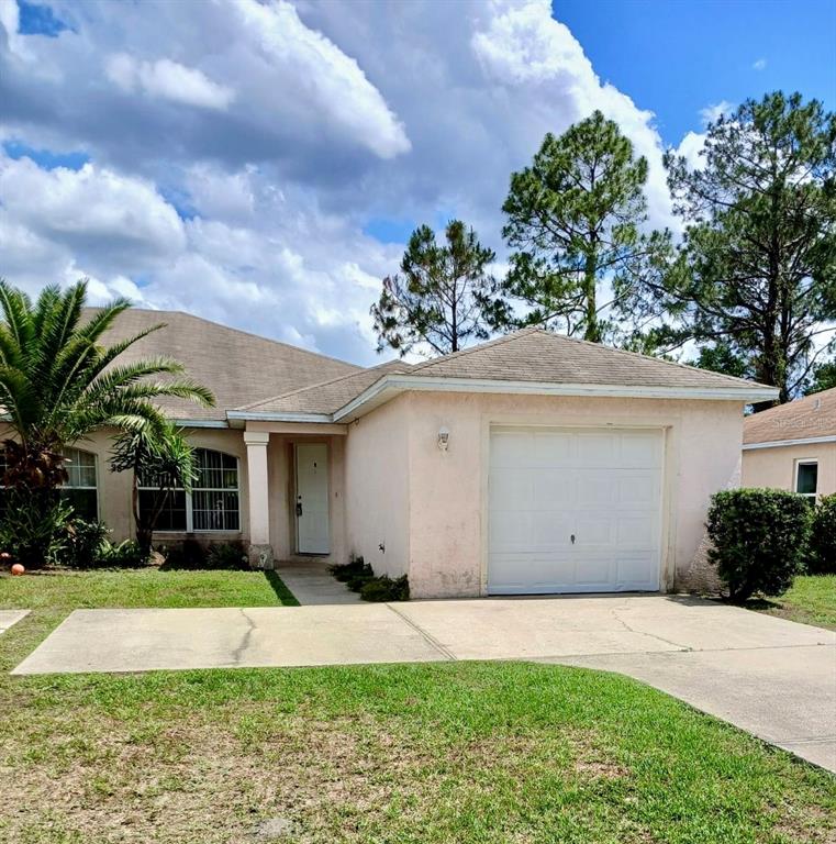 a view of a house with a garden and yard