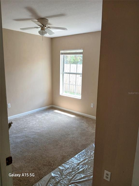 28 Plateau Lane, Unit B Palm Coast, FL 32164 - Photo 3 of 7 a view of empty room with windows