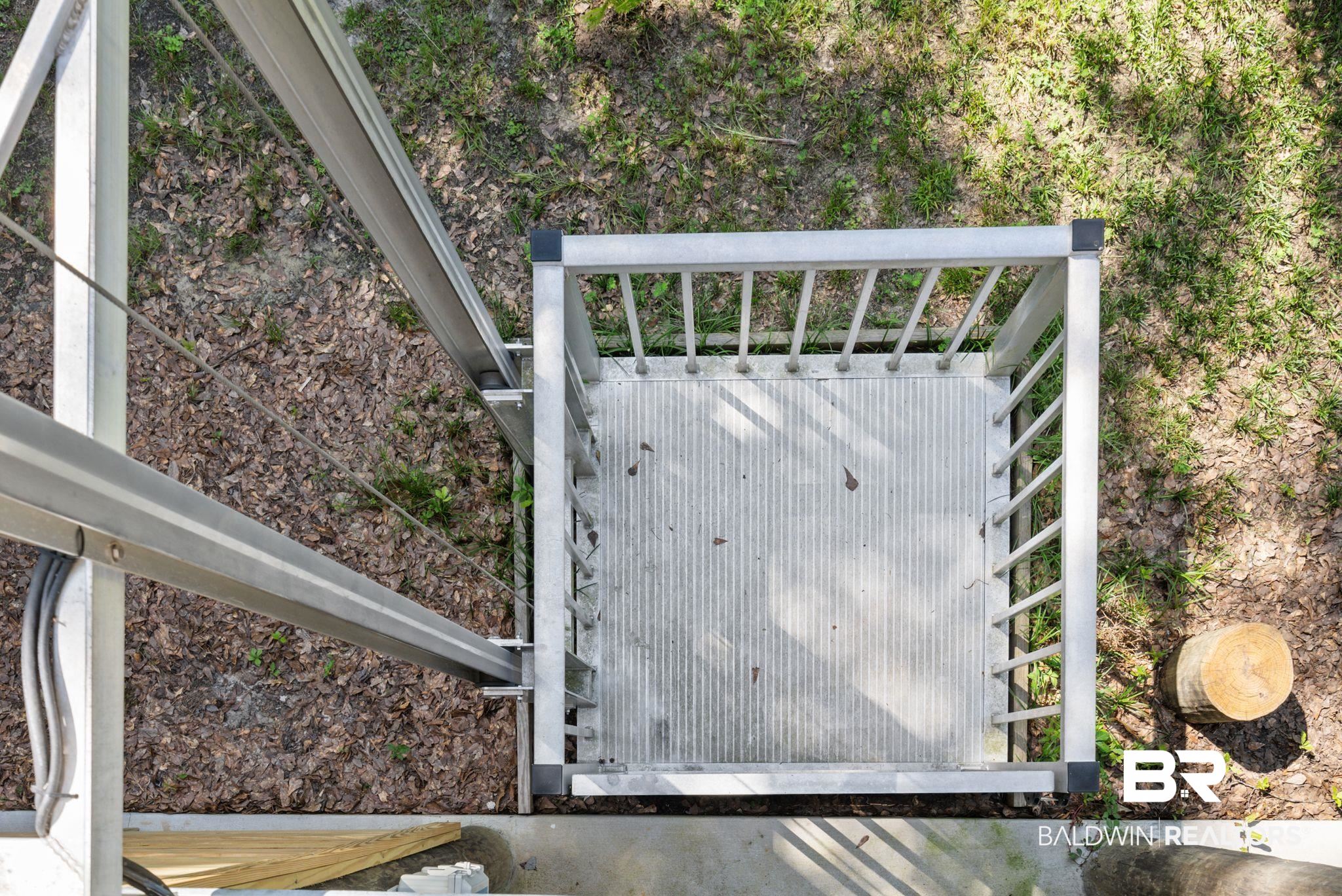 7266 Franklin Road Foley, AL 36535 - Photo 10 of 64 Exterior mechanical lift featuring a metal platform with textured flooring, robust railing, and aluminum support structure