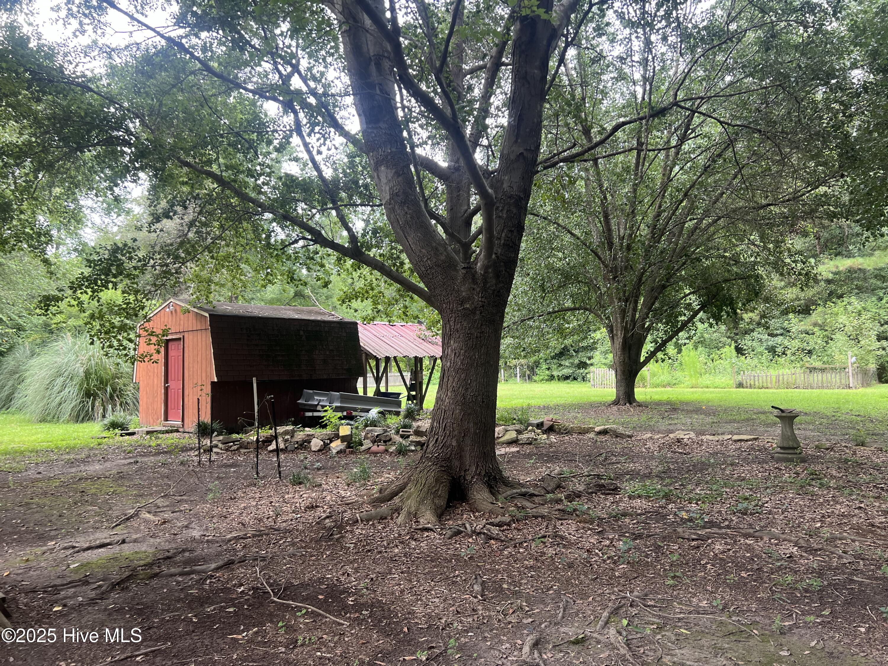 1413 Bud Hawkins Road Dunn, NC 28334 - Photo 12 of 56 This home is situated on over 2.5 acres and the barn and shelter is great for storage....just bring the chickens....