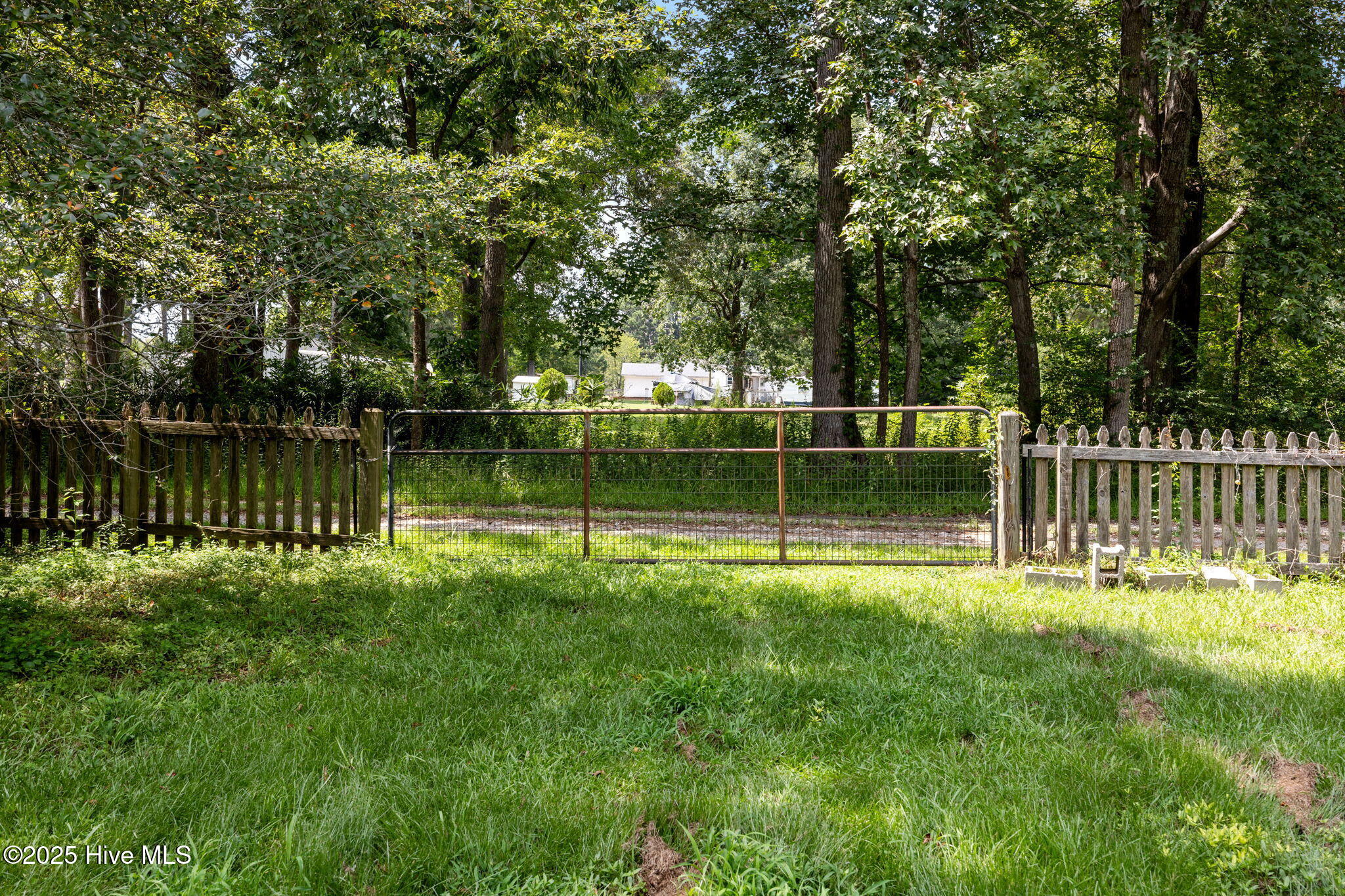 1413 Bud Hawkins Road Dunn, NC 28334 - Photo 51 of 56 The easement on left of home is highlighted with nice gate to come in from side area if needed.