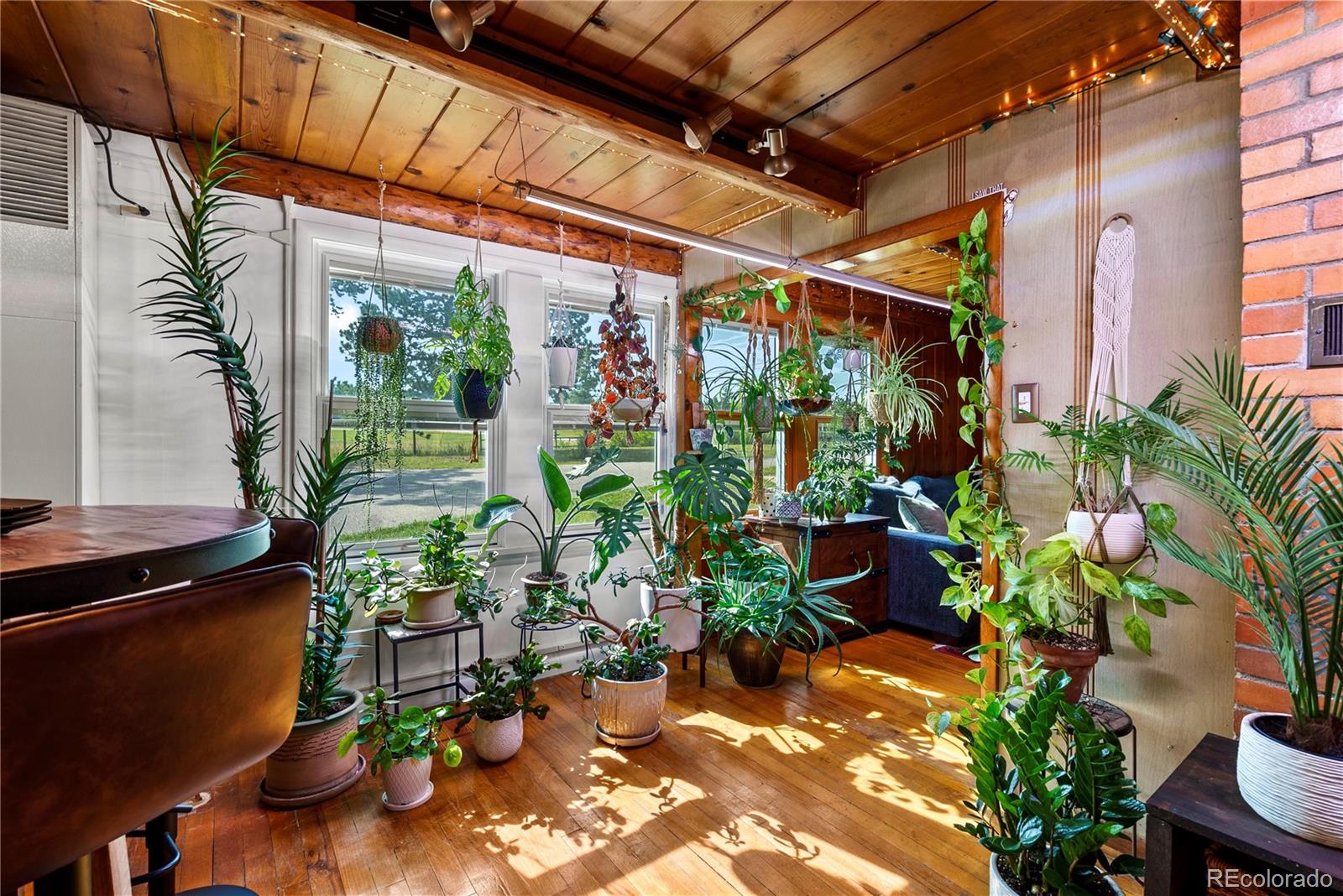 21852 Pleasant Park Road Conifer, CO 80433 - Photo 13 of 47 a view of a porch with chairs and potted plants