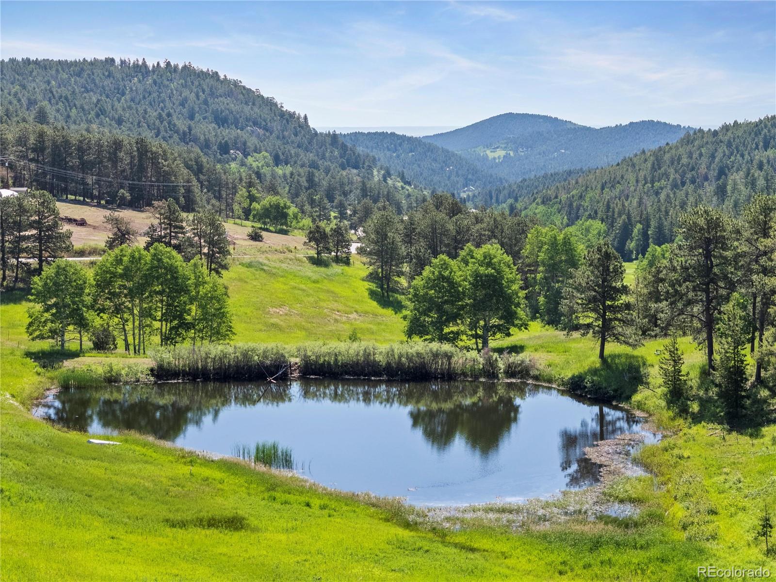 21852 Pleasant Park Road Conifer, CO 80433 - Photo 2 of 47 a view of lake with mountain
