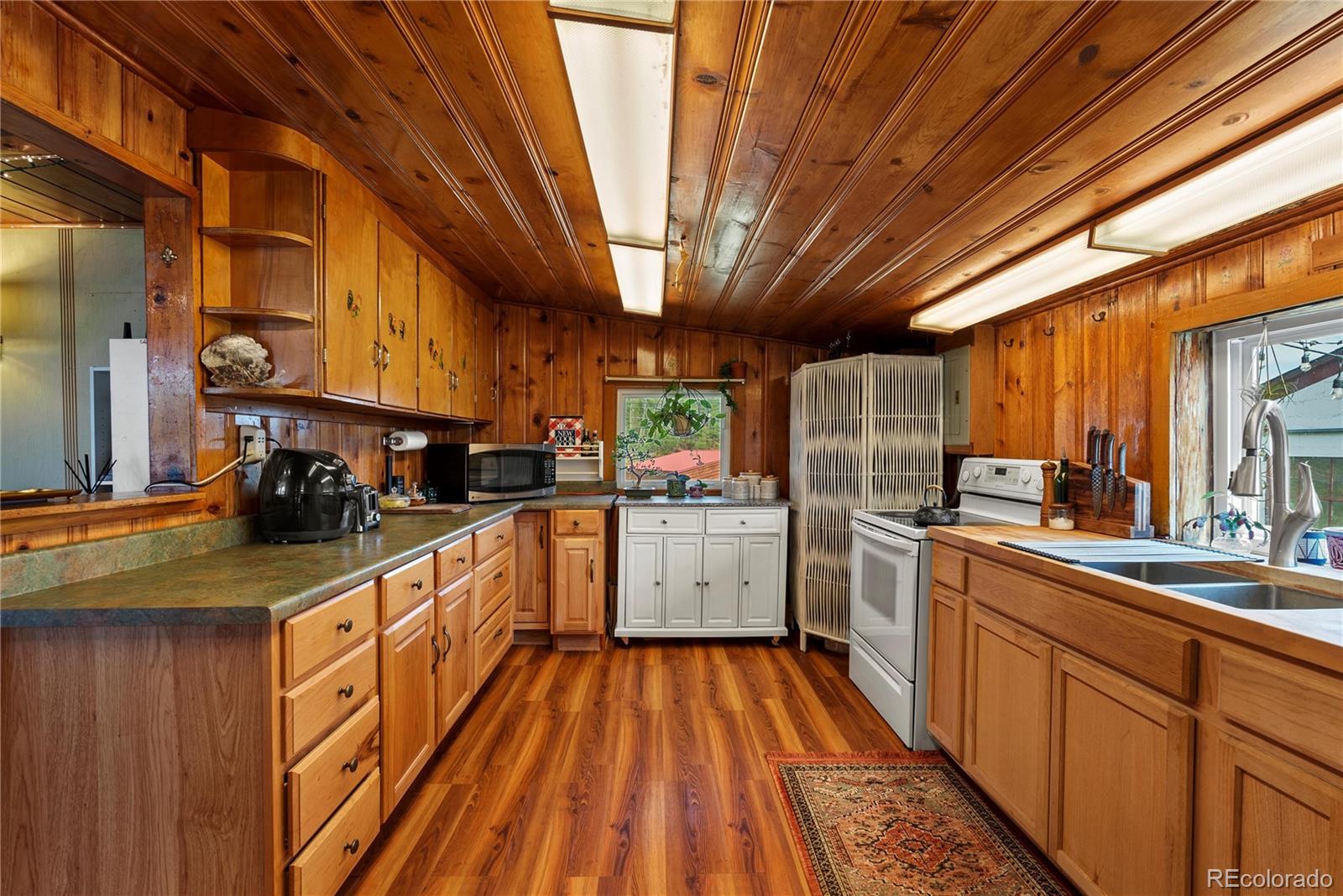 21852 Pleasant Park Road Conifer, CO 80433 - Photo 24 of 47 a kitchen with stainless steel appliances granite countertop lots of counter top space