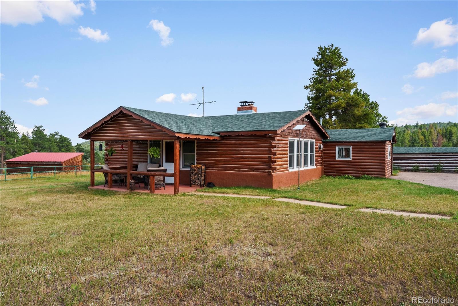 21852 Pleasant Park Road Conifer, CO 80433 - Photo 29 of 47 a front view of a house with garden