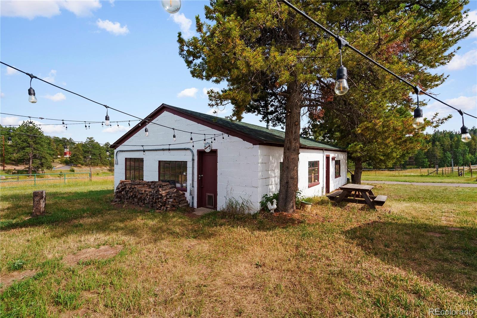 21852 Pleasant Park Road Conifer, CO 80433 - Photo 30 of 47 a view of a house with a yard