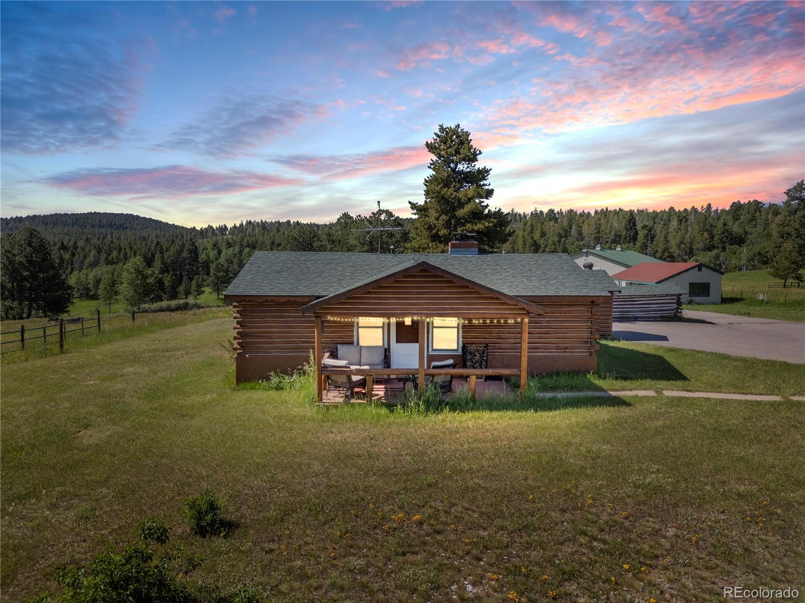21852 Pleasant Park Road Conifer, CO 80433 - Photo 3 of 47 a view of a big house with a big yard