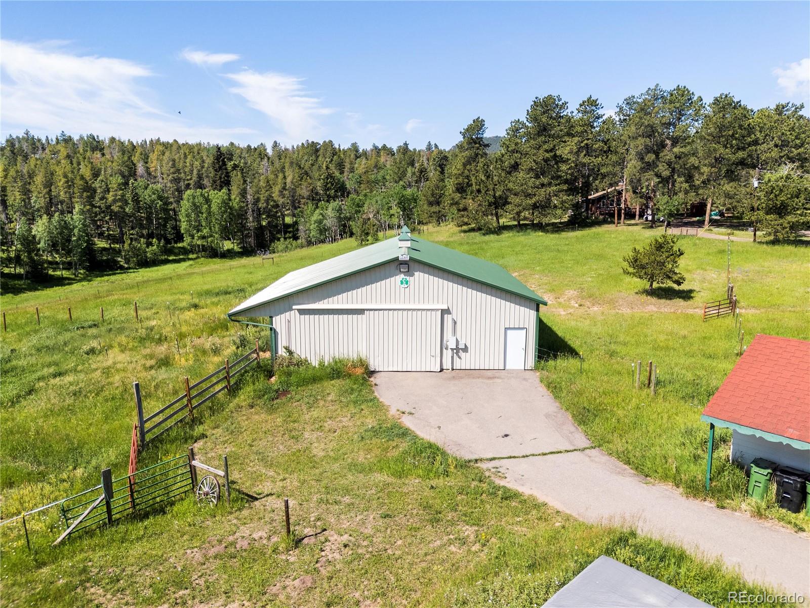 21852 Pleasant Park Road Conifer, CO 80433 - Photo 31 of 47 a view of a backyard with plants and lake view