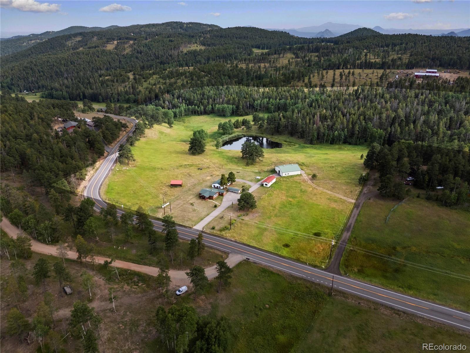 21852 Pleasant Park Road Conifer, CO 80433 - Photo 38 of 47 a view of a lake with a mountain in the background