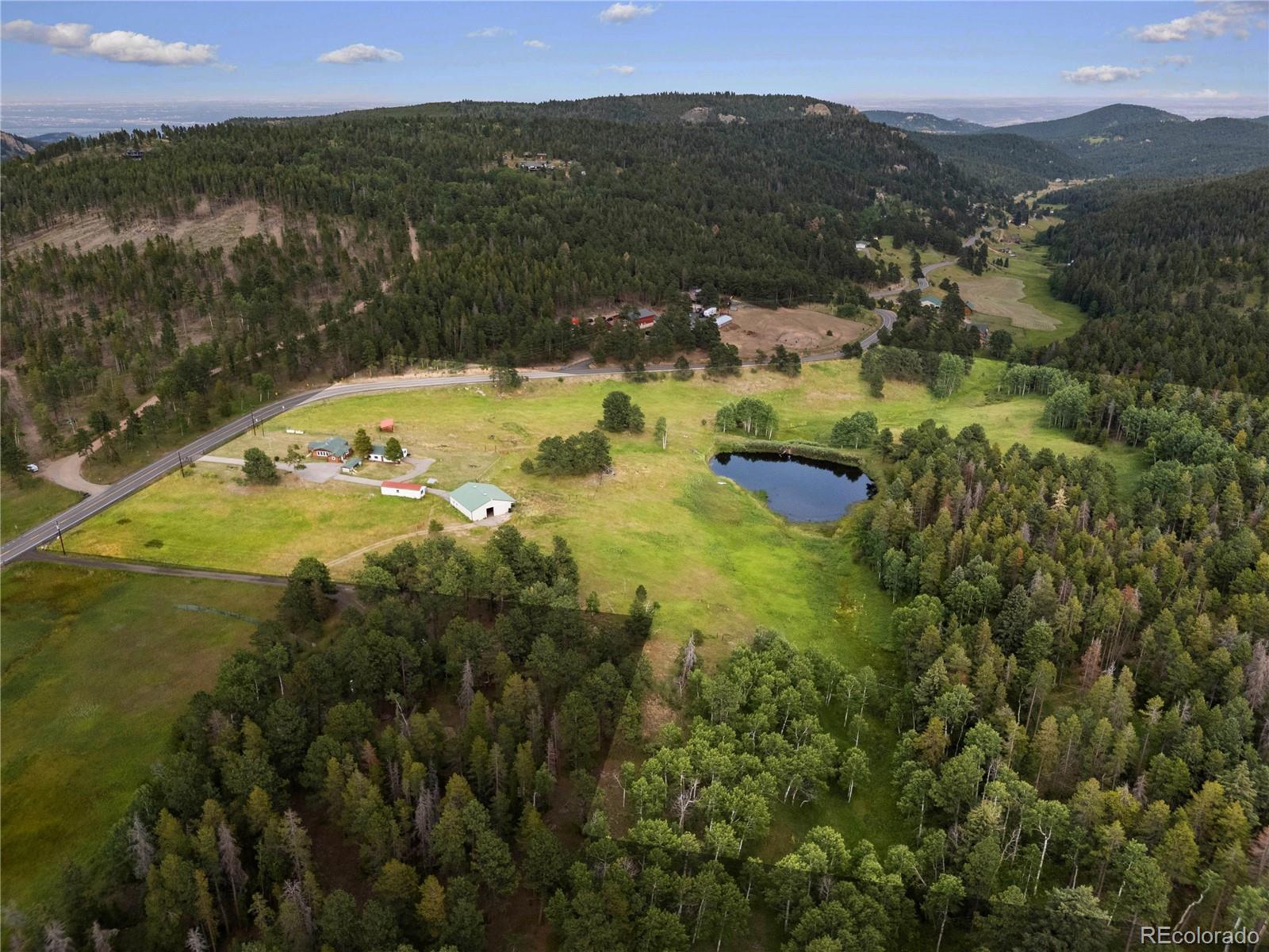 21852 Pleasant Park Road Conifer, CO 80433 - Photo 41 of 47 a view of a lake with a mountain