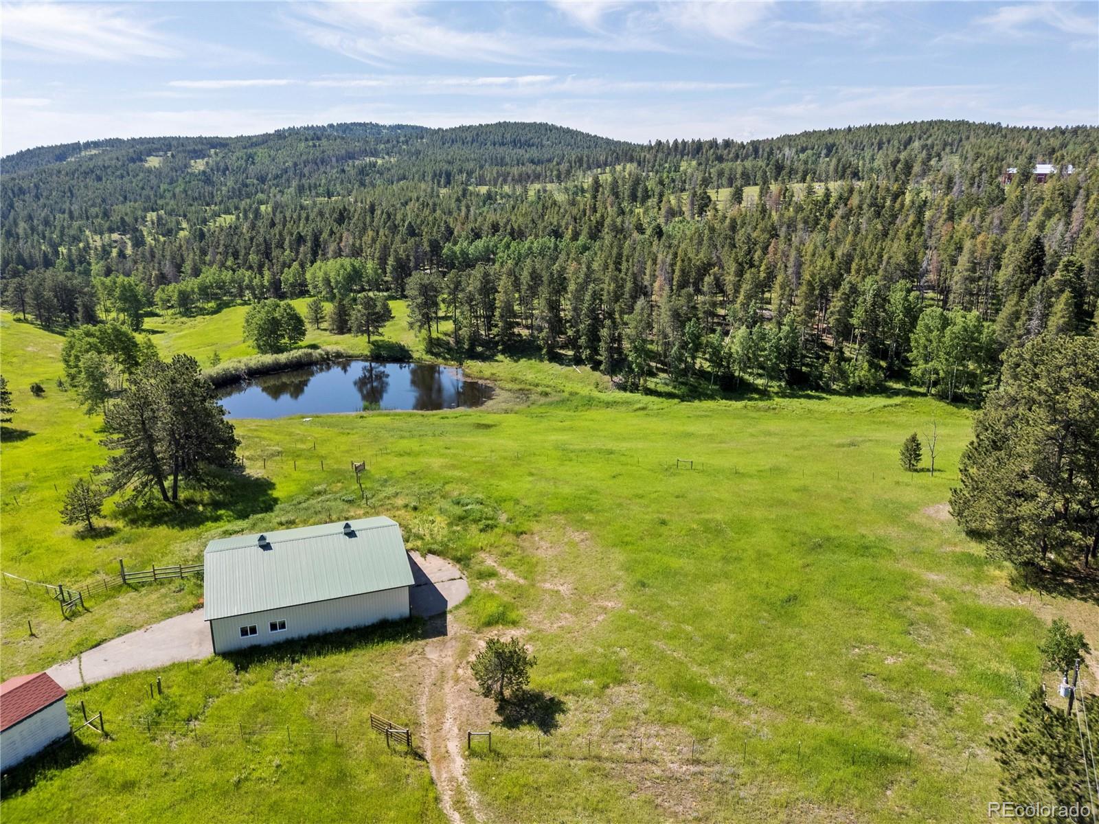 21852 Pleasant Park Road Conifer, CO 80433 - Photo 42 of 47 a view of a lake with a mountain in the background