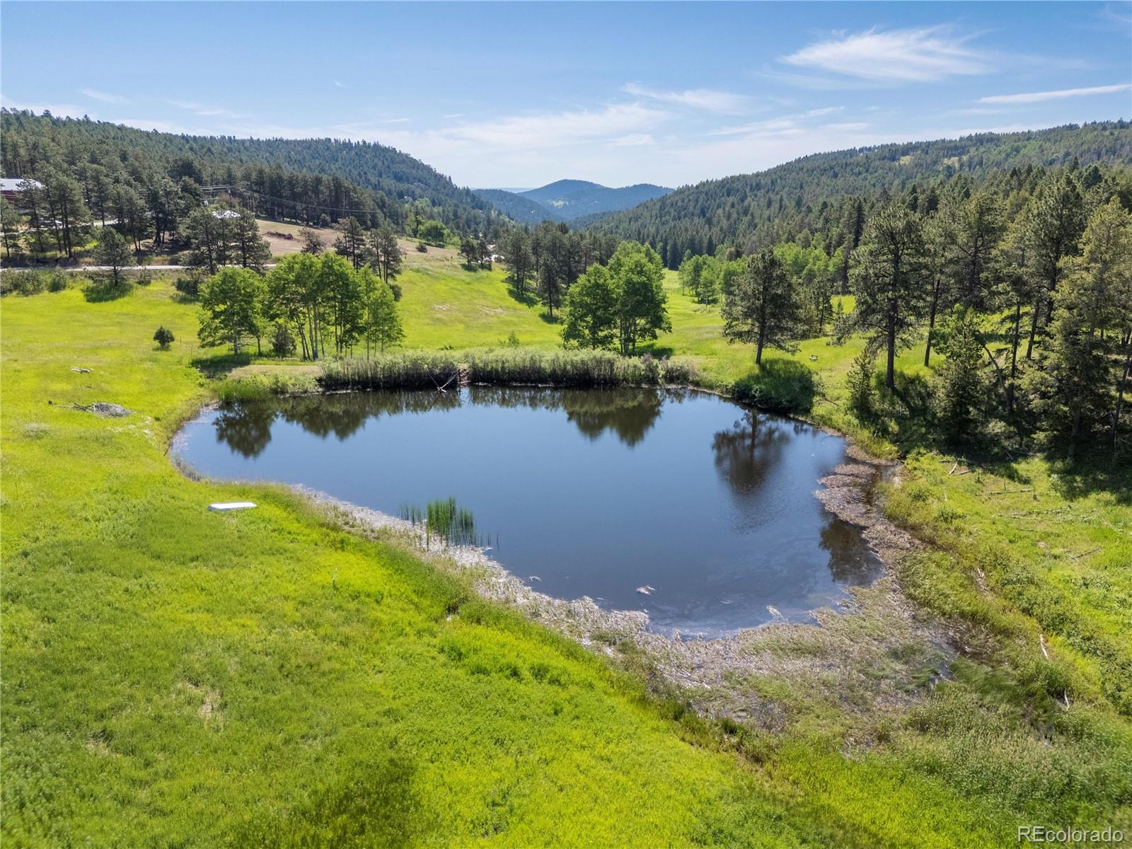 21852 Pleasant Park Road Conifer, CO 80433 - Photo 43 of 47 a view of a lake with a mountain