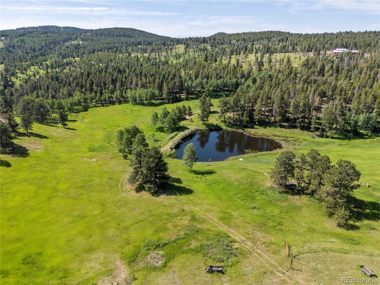 21852 Pleasant Park Road Conifer, CO 80433 - Photo 44 of 47 a view of a lake with a mountain in the background