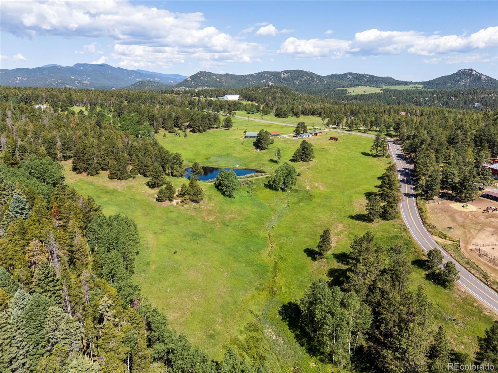 21852 Pleasant Park Road Conifer, CO 80433 - Photo 45 of 47 a view of a city with mountains in the background