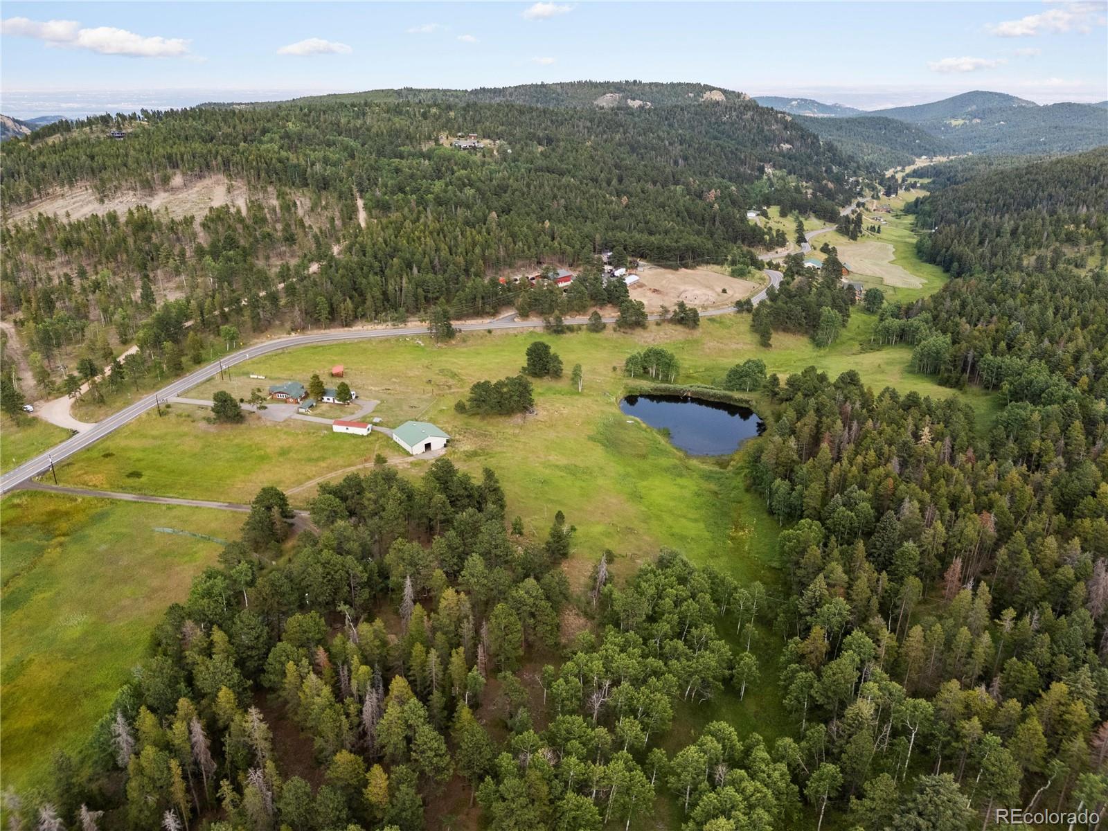 21852 Pleasant Park Road Conifer, CO 80433 - Photo 47 of 47 a view of a lake with mountains in the background