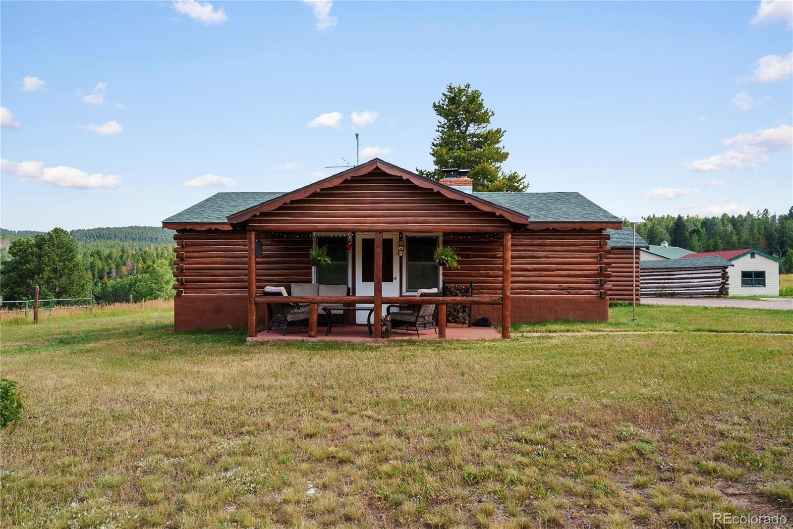 21852 Pleasant Park Road Conifer, CO 80433 - Photo 6 of 47 a view of a house with garden and sitting area