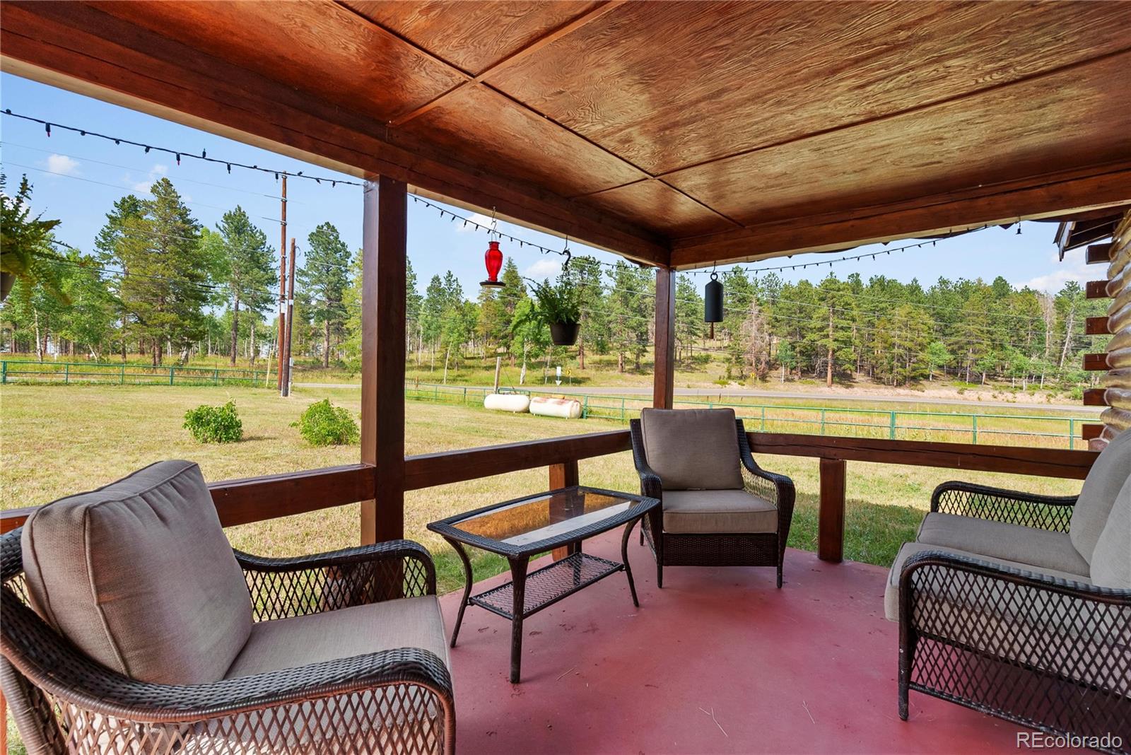 21852 Pleasant Park Road Conifer, CO 80433 - Photo 7 of 47 a view of a chairs and couches in the patio