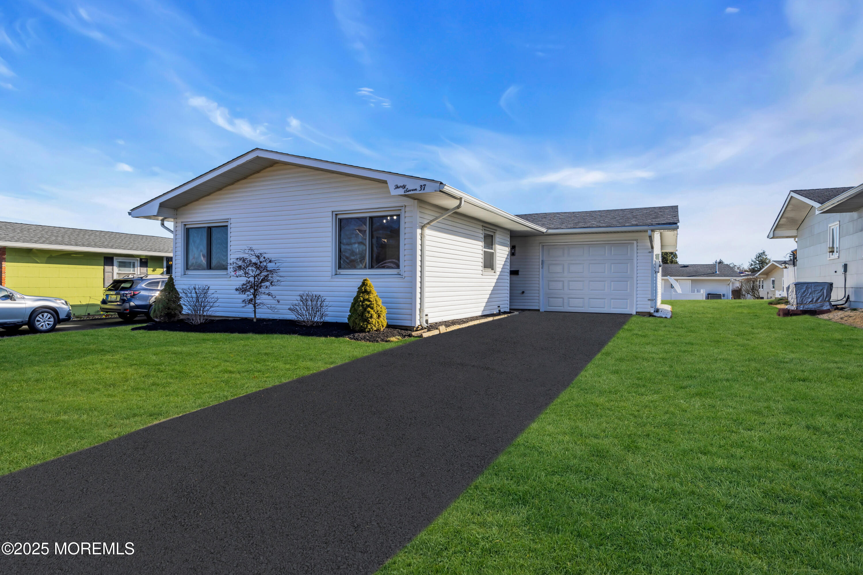 a front view of house with yard and green space