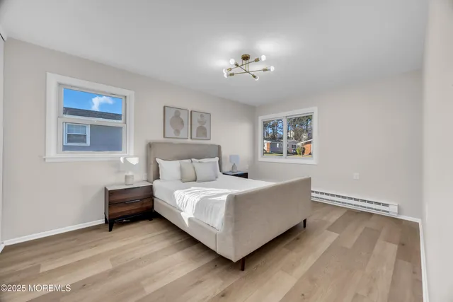 a bedroom with a bed and a chandelier