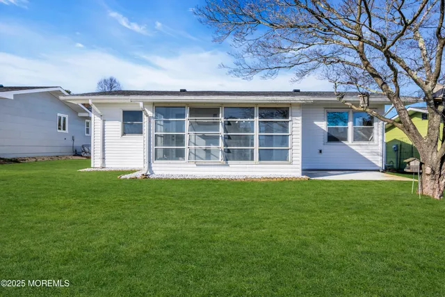 a view of a house with a backyard