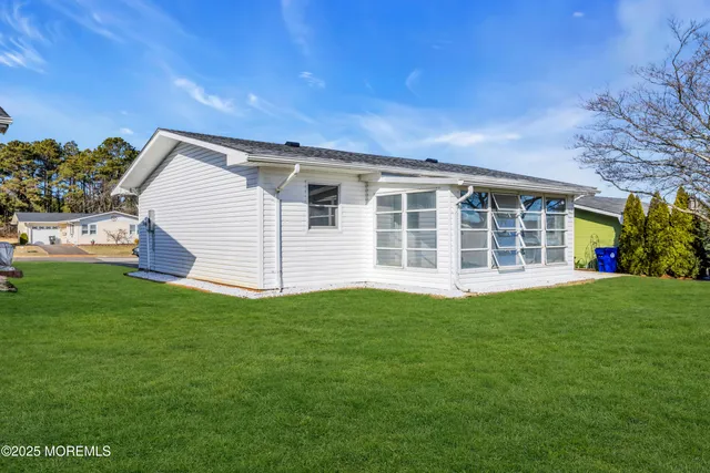 a view of a house with a backyard