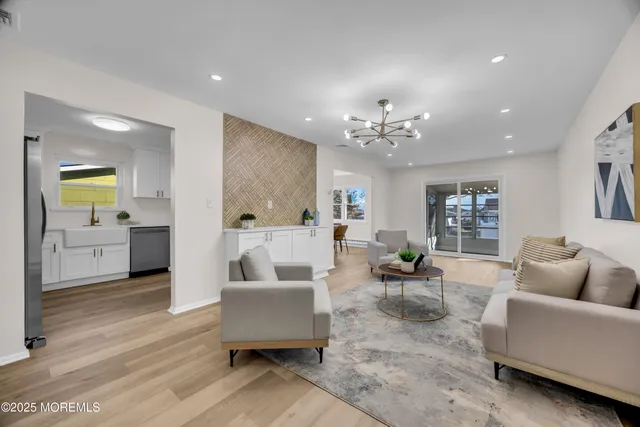 a living room with furniture and a chandelier