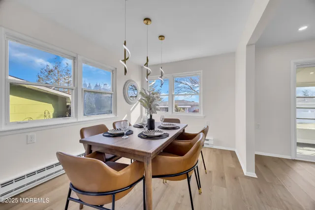 a view of a dining room with furniture and wooden floor