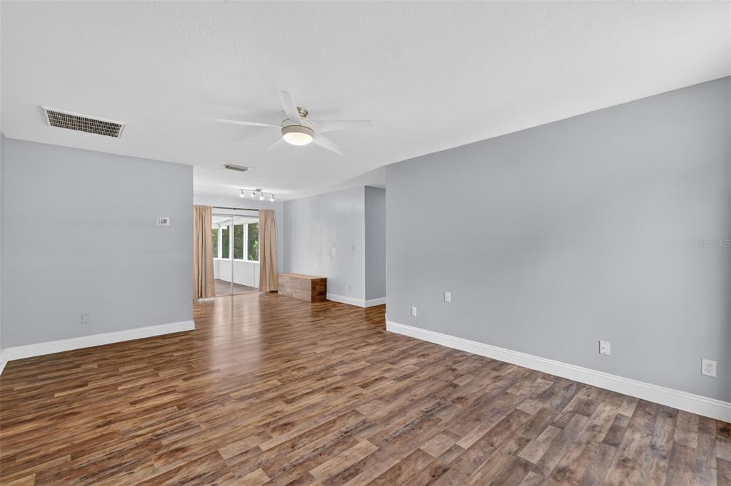 36 Bay Ridge Loop Mascotte, FL 34753 - Photo 7 of 32 wooden floor in an empty room with a window